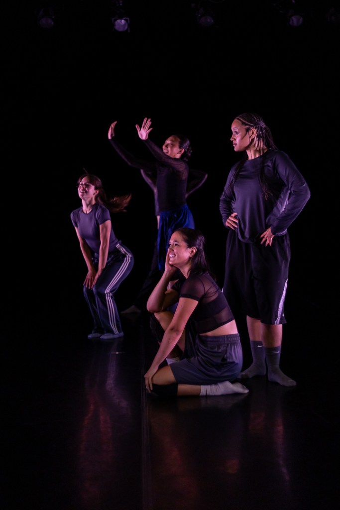 dancers clustered in thoughful observation