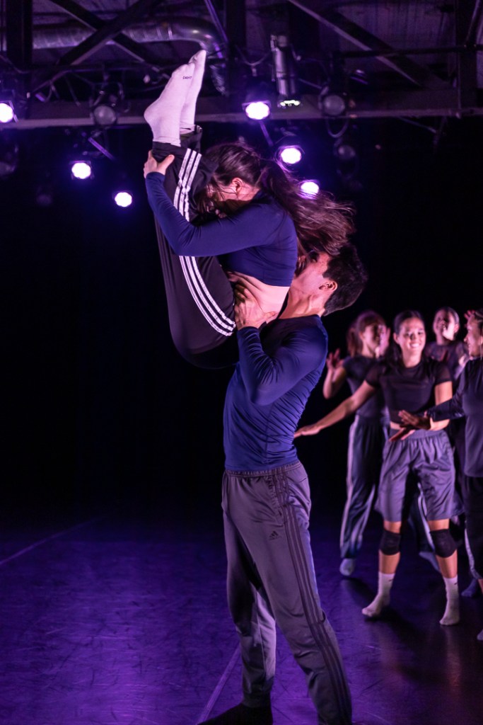 one dancer holding a pike with toes pointed, lifted by another dancer