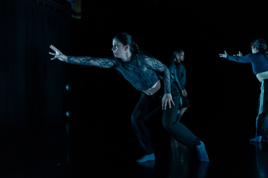 dancer in low lunge reachin forward